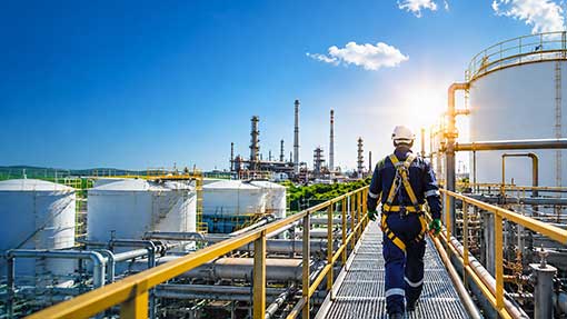 engineer walking next to fuel tanks